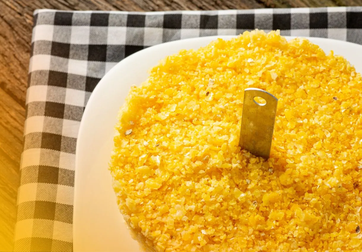 DALL·E 2024 05 30 16.29.23 A table with all the ingredients for making traditional Cuscuz de Milho Nordestino 2 cups of flaked cornmeal 1 cup of water 1 2 teaspoon of salt 1