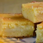 DALL·E 2024 06 03 09.34.29 A kitchen counter with ingredients for a cornmeal fuba cake with condensed milk. The ingredients include cornmeal flour sugar eggs milk condens