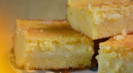 DALL·E 2024 06 03 09.34.29 A kitchen counter with ingredients for a cornmeal fuba cake with condensed milk. The ingredients include cornmeal flour sugar eggs milk condens