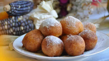 DALL·E 2024 06 05 16.07.31 A table with all the ingredients needed for making bolinho de chuva flour sugar eggs milk baking powder oil and a mixture of sugar and cinnamon