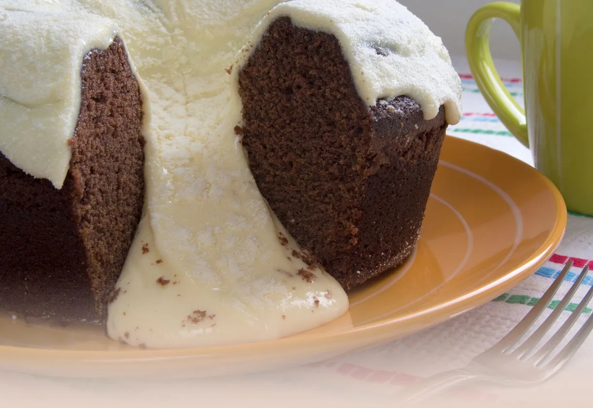 DALL·E 2024 06 06 10.14.53 A high quality image showing the ingredients for making a Bolo Vulcao cake neatly arranged on a wooden kitchen counter. The ingredients include eggs 2