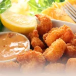 DALL·E 2024 06 06 10.22.07 A detailed high quality image of all the ingredients for making breaded shrimp laid out on a clean white countertop. The ingredients include 500g of 1